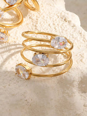 Close-up of three oval clear stones on a stacked open ring