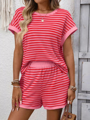 Three-quarter view of the coral-pink striped T-shirt and shorts.