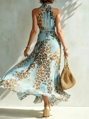 Full-length view of sky-blue leopard-print halter maxi dress with high slit