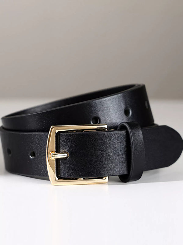 Black belt with gold-coloured rectangular buckle and single keeper, rolled close-up