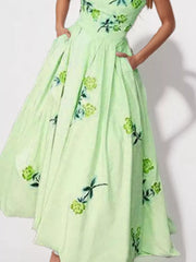 Detail of the light green floral maxi dress skirt and gathered waist.