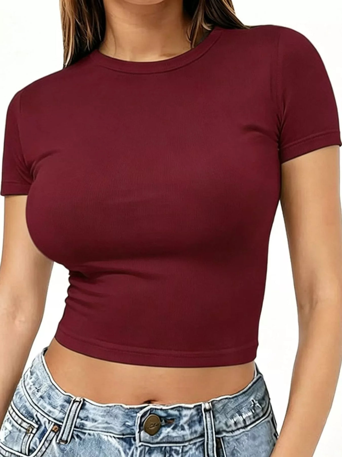 Burgundy crew-neck crop T-shirt worn with light wash jeans, front view.
