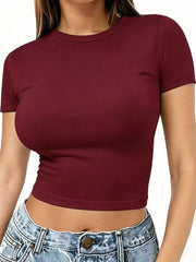 Burgundy crew-neck crop T-shirt worn with light wash jeans, front view.