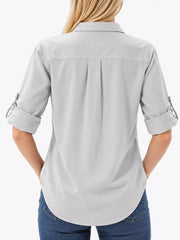 Back view of light gray button-down shirt with rolled sleeves