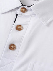 Close-up of contrast buttons on white polo shirt