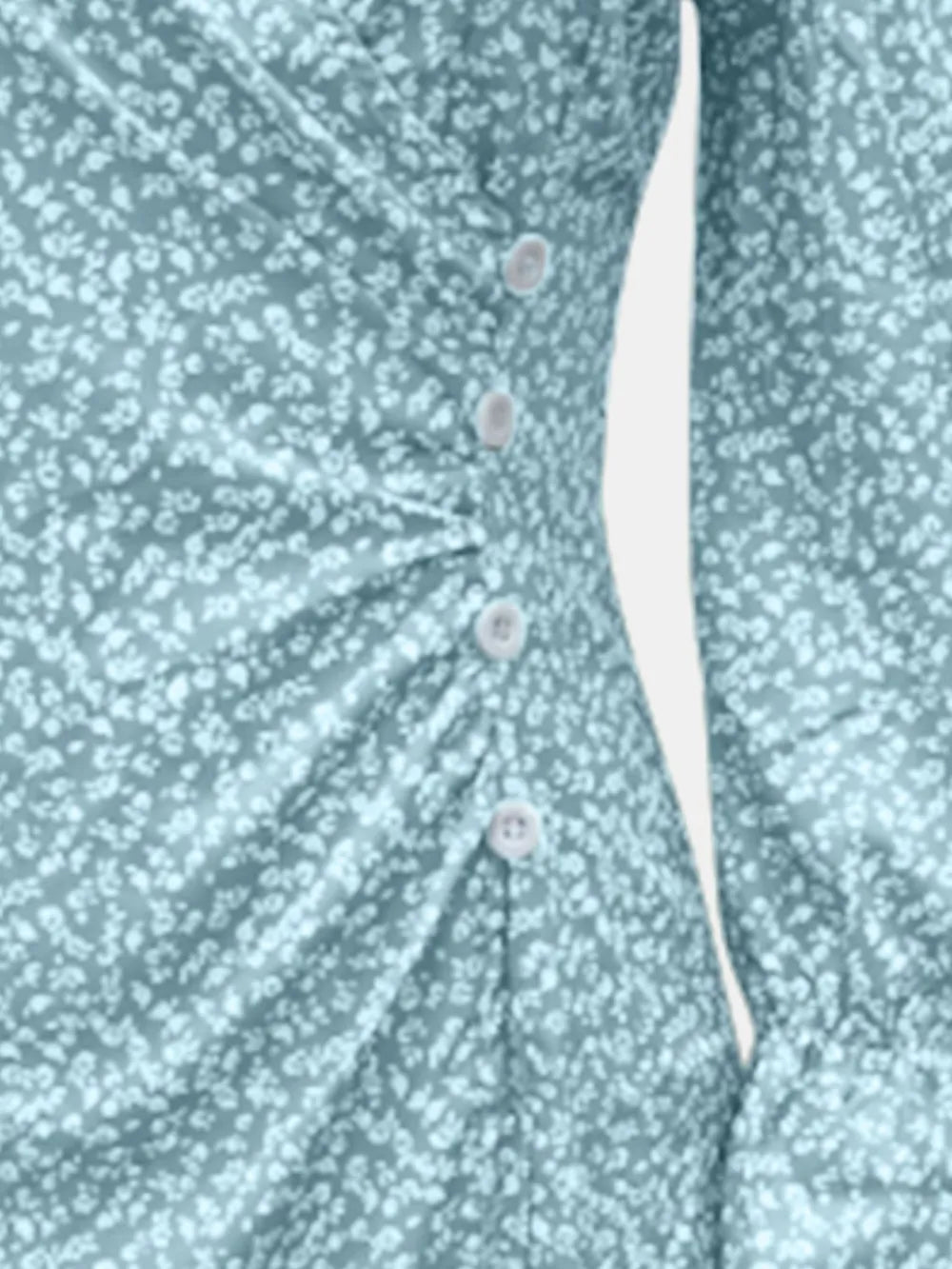 Close-up of mint blue dress print, waist ruching and button detail