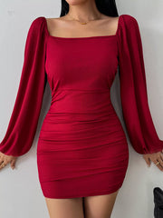 Rear view of burgundy fitted dress with an open back and ruched skirt