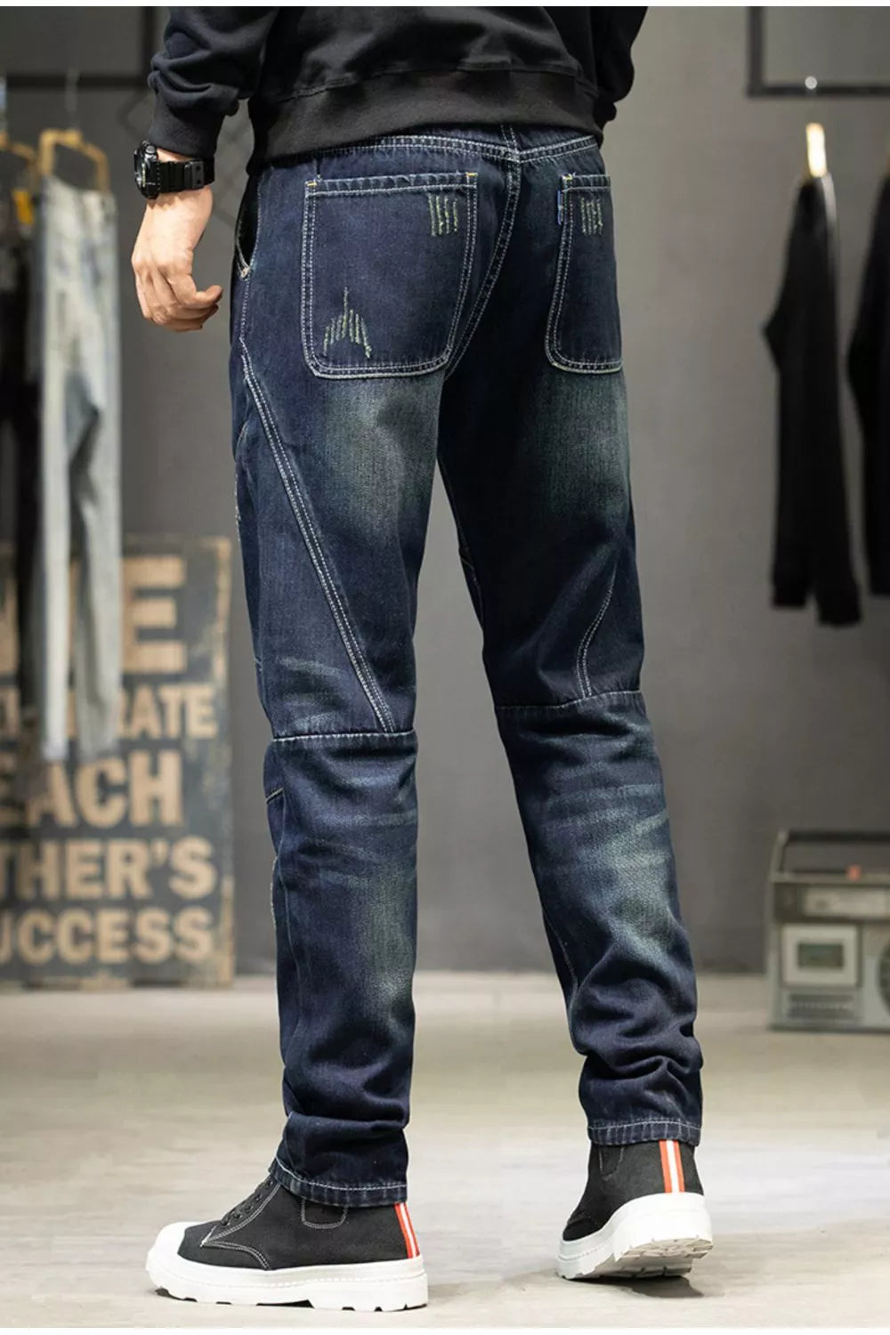 Back view of dark blue straight-leg jeans with patch pockets and contrast seams