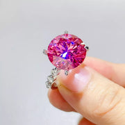 Pink centre-stone ring held close-up against white box