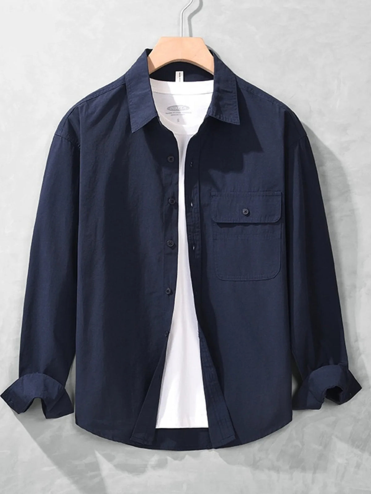 Navy long-sleeve button-up men's shirt displayed from the front with chest pocket and button placket
