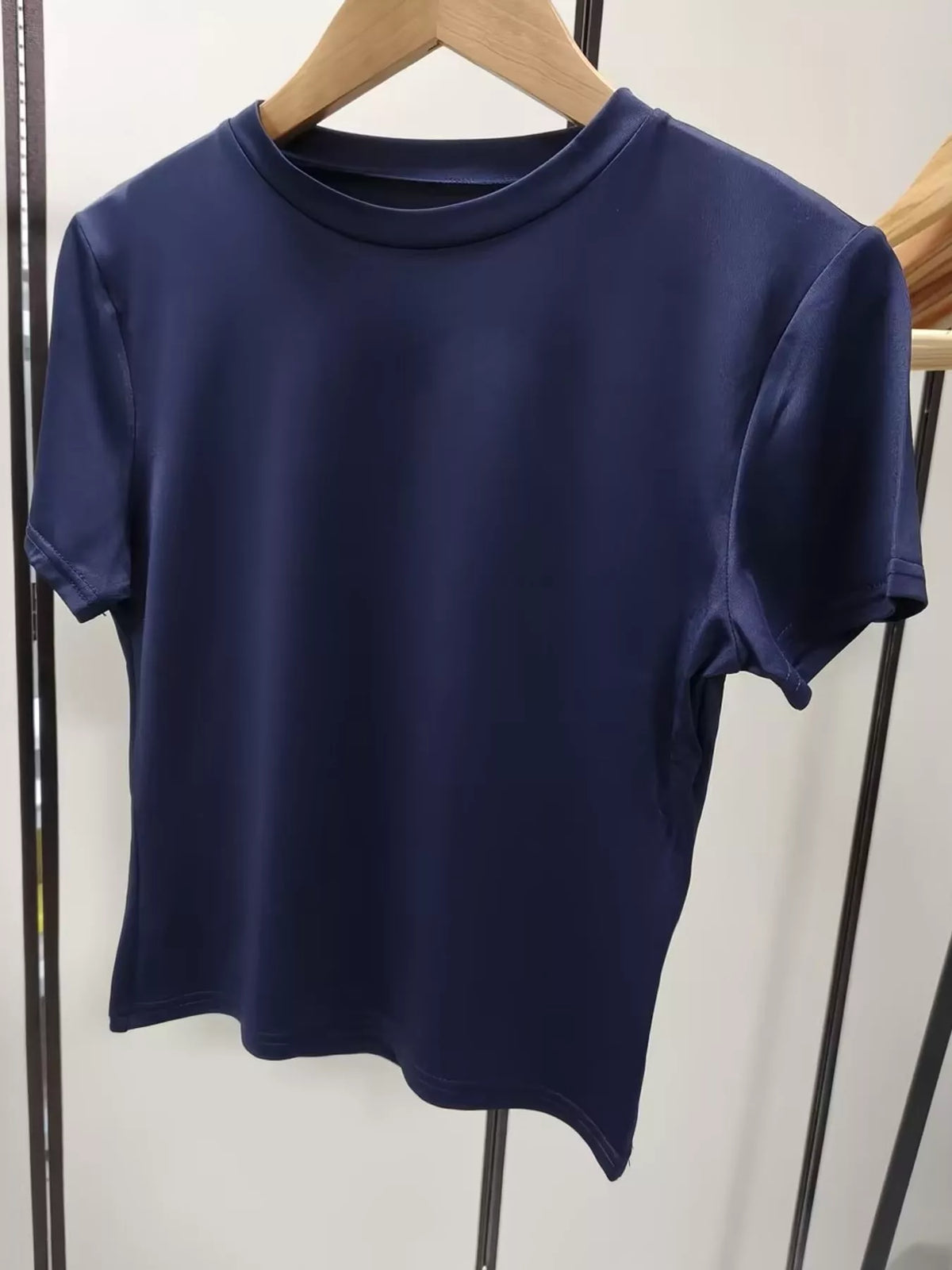 Navy short-sleeve cropped crew neck T-shirt, front product view.