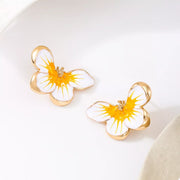 Pair of yellow-and-white flower studs viewed at an angle