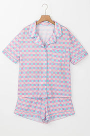 Front view of pink-and-white plaid button-up top and shorts