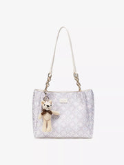 Pale jacquard tote with detachable teddy charm, straight-on view