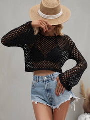 Sage green cropped open-knit cover-up with a round neck, shown on a model.