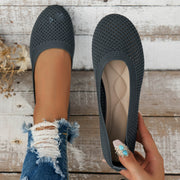Pair of dark charcoal mesh flats viewed from above, showing insoles