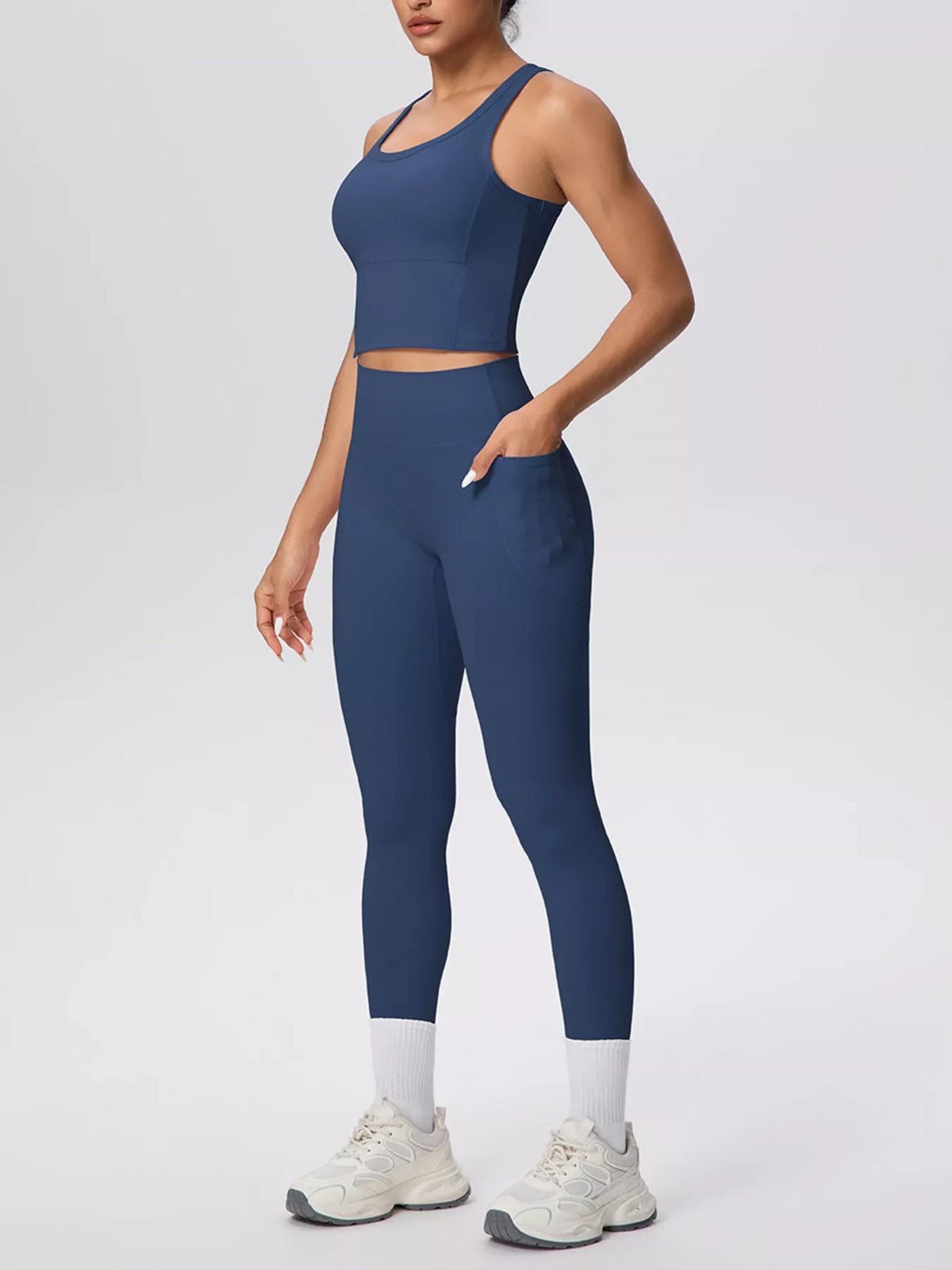 Navy scoop-neck tank and high-waisted leggings, front three-quarter view