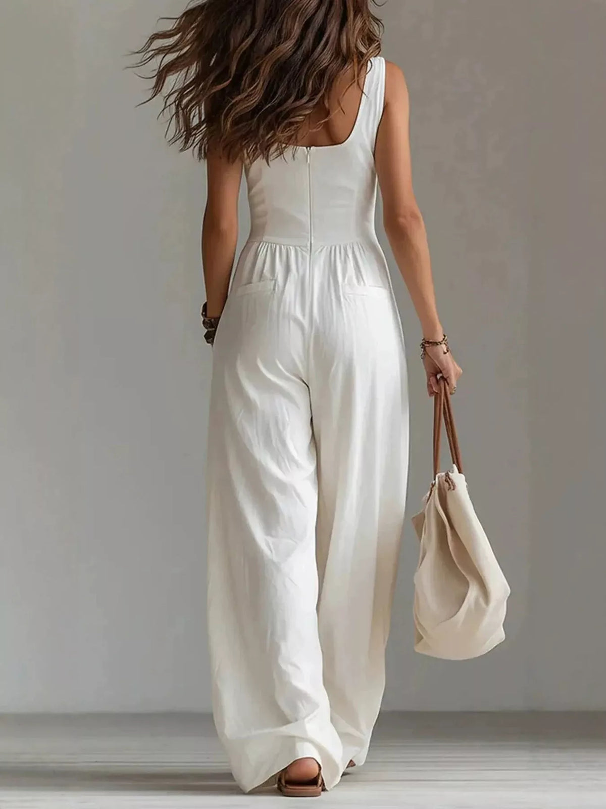 Back view of white jumpsuit with waist seam and wide-leg pants