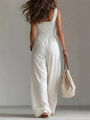 Back view of white jumpsuit with waist seam and wide-leg pants
