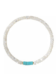 White beaded bracelet with turquoise centerpiece arranged in a circle on a light background