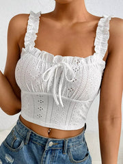 Close-up of white eyelet bodice and ruffled straps with front tie