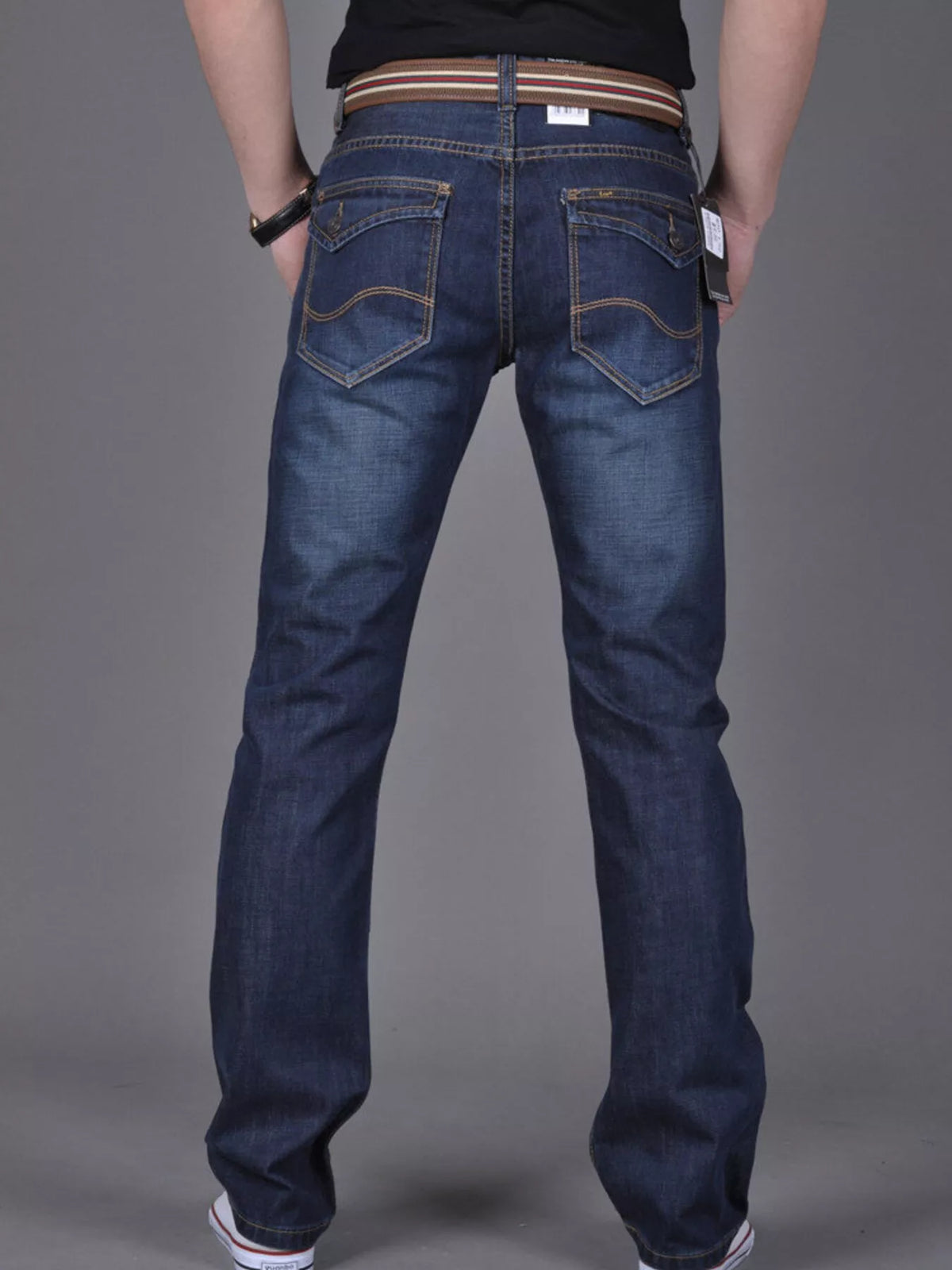 Dark blue slim-fit jeans modeled from the back