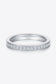 Low side view of a narrow moissanite band with a row of stones on white.