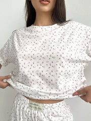 Close view of the top's small floral print and short sleeves