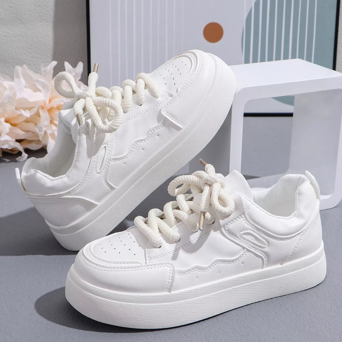 Pair of white platform sneakers on display