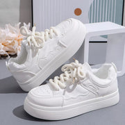 Pair of white platform sneakers on display
