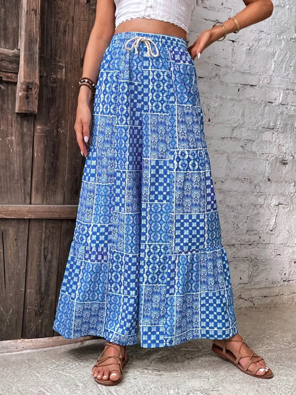 Blue patterned high-waisted wide-leg pants worn with a white top, front view