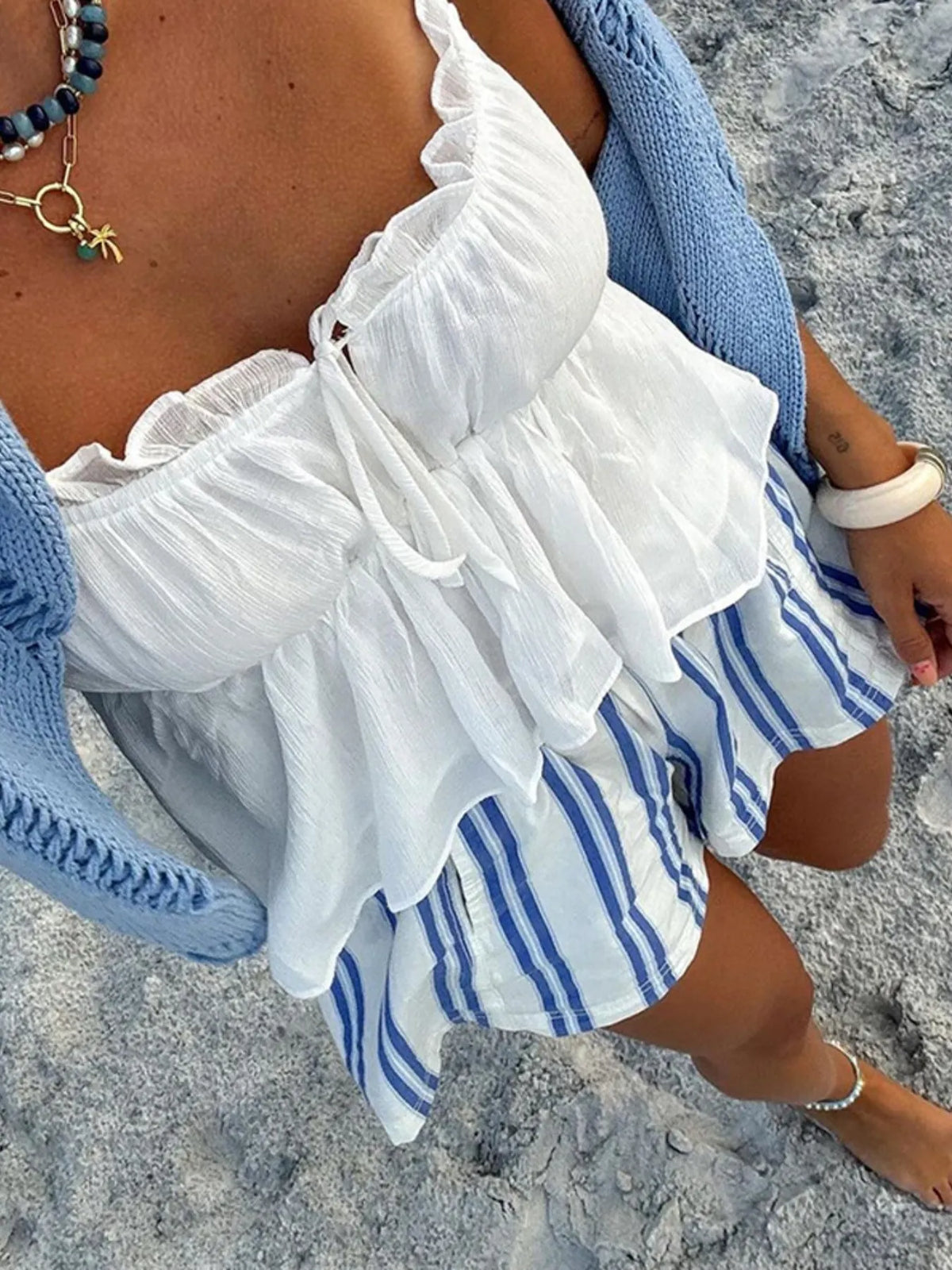 Overhead beach outfit with white and blue striped shorts
