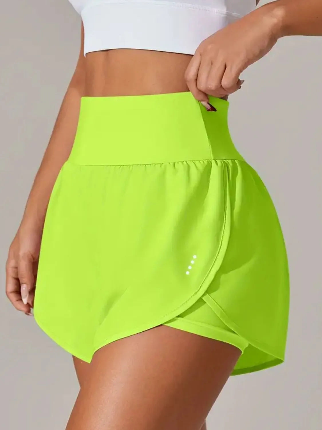 Neon lime shorts with overlapping wrap panel, side view