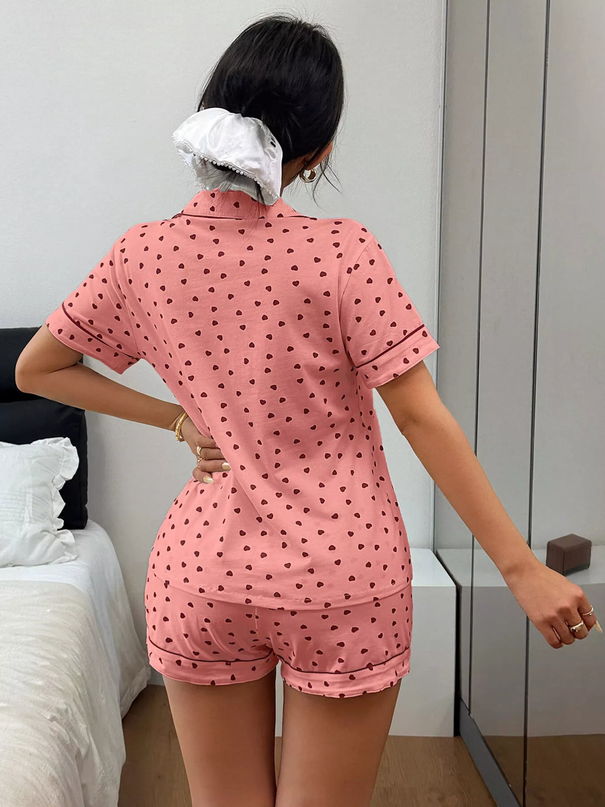 Back view of pink heart-print pajama shirt and shorts