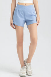 Full-length front view of light blue elastic-waist active shorts