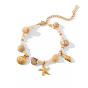 Gold shell bracelet displayed against a light background
