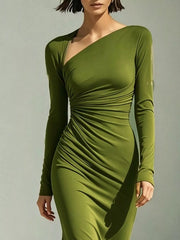 Close-up of the green dress's diagonal neckline, fitted sleeve and side gathers.
