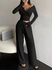 Front view of black two-piece set with buttoned neckline and drawstring pants
