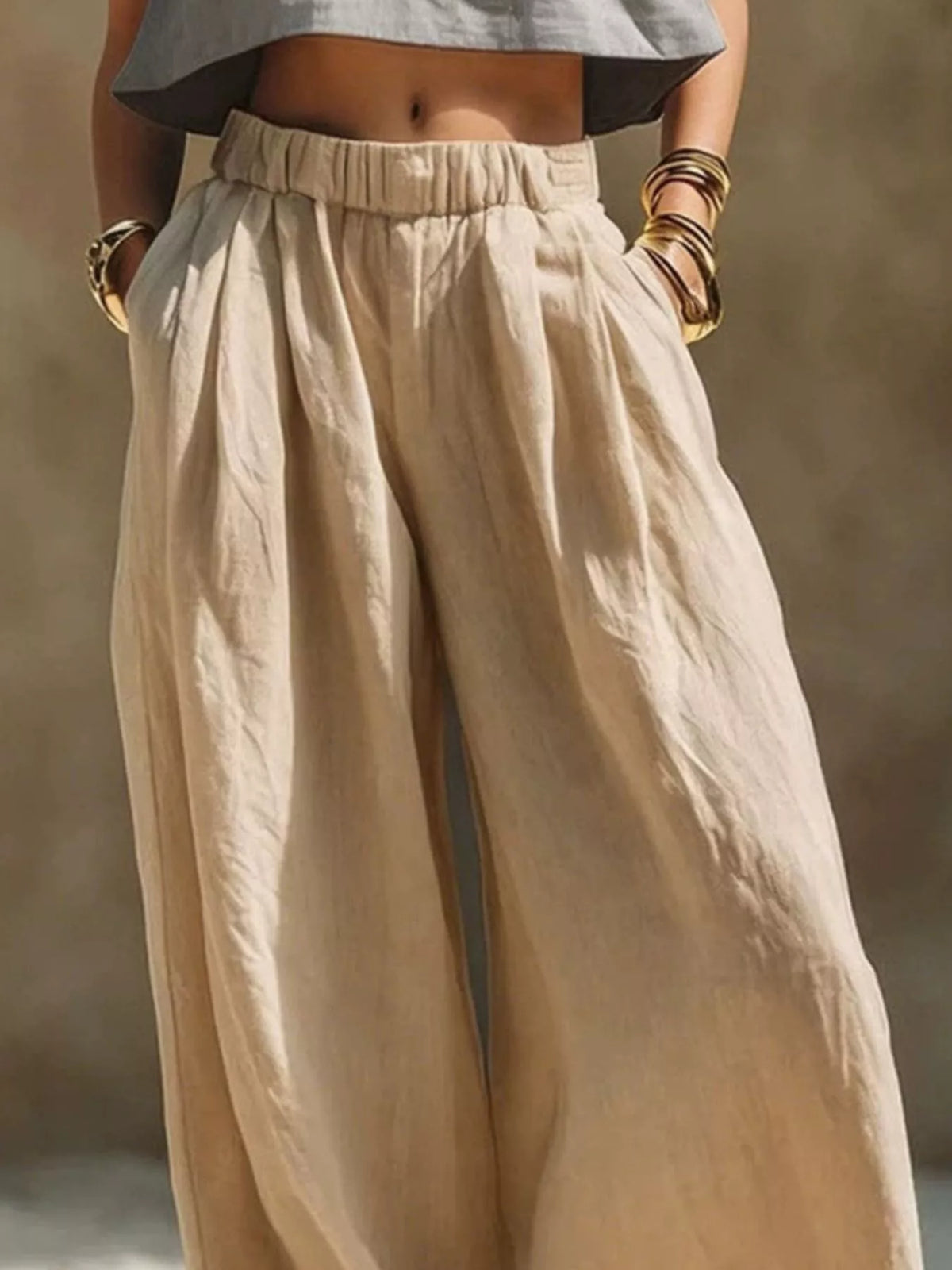 Front view of beige wide-leg pants with gathered waistband and pockets