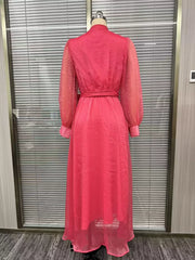 Back view of the pink long-sleeve maxi dress on a dress form, showing its waist tie.