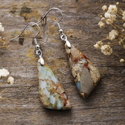 Pair of pale blue and cream geometric drop earrings with silver-tone hooks