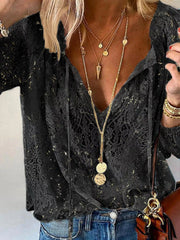 Black sheer lace tie-neck blouse with long loose sleeves and V neckline