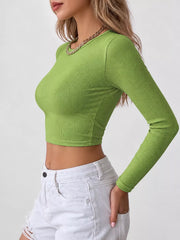 Side view of the green long-sleeve crop top with a close fit