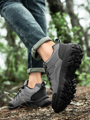 Grey lace-up shoe worn on a log with the deep black outsole visible