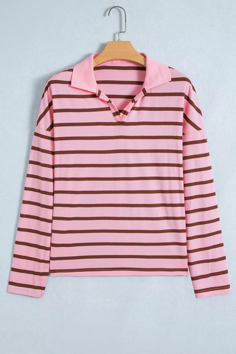 Pink striped shirt on a hanger, front view with collar and button placket.