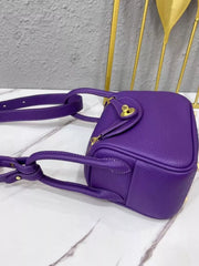 Side view of the purple crossbody bag showing its base