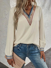 Contrast V-neck long-sleeve blouse in cream front pose with hand at neckline