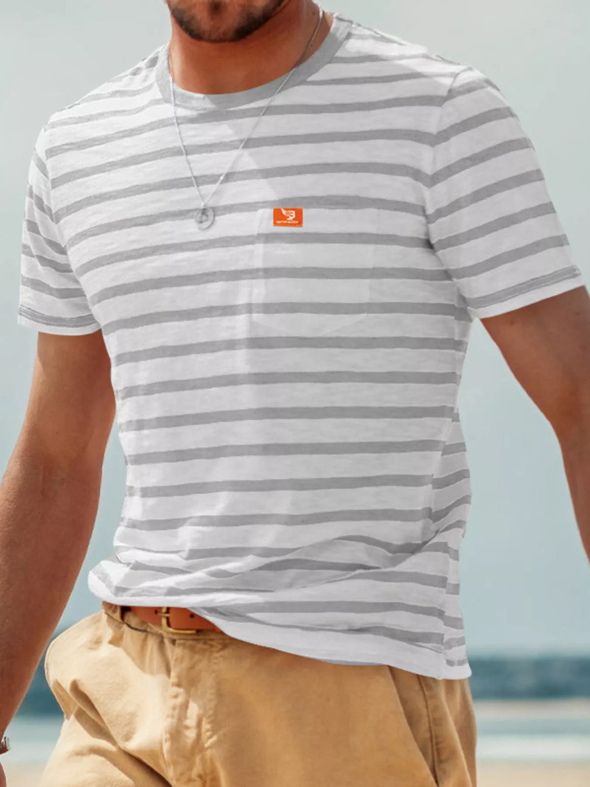 Front view of model wearing gray-and-white striped pocket T-shirt