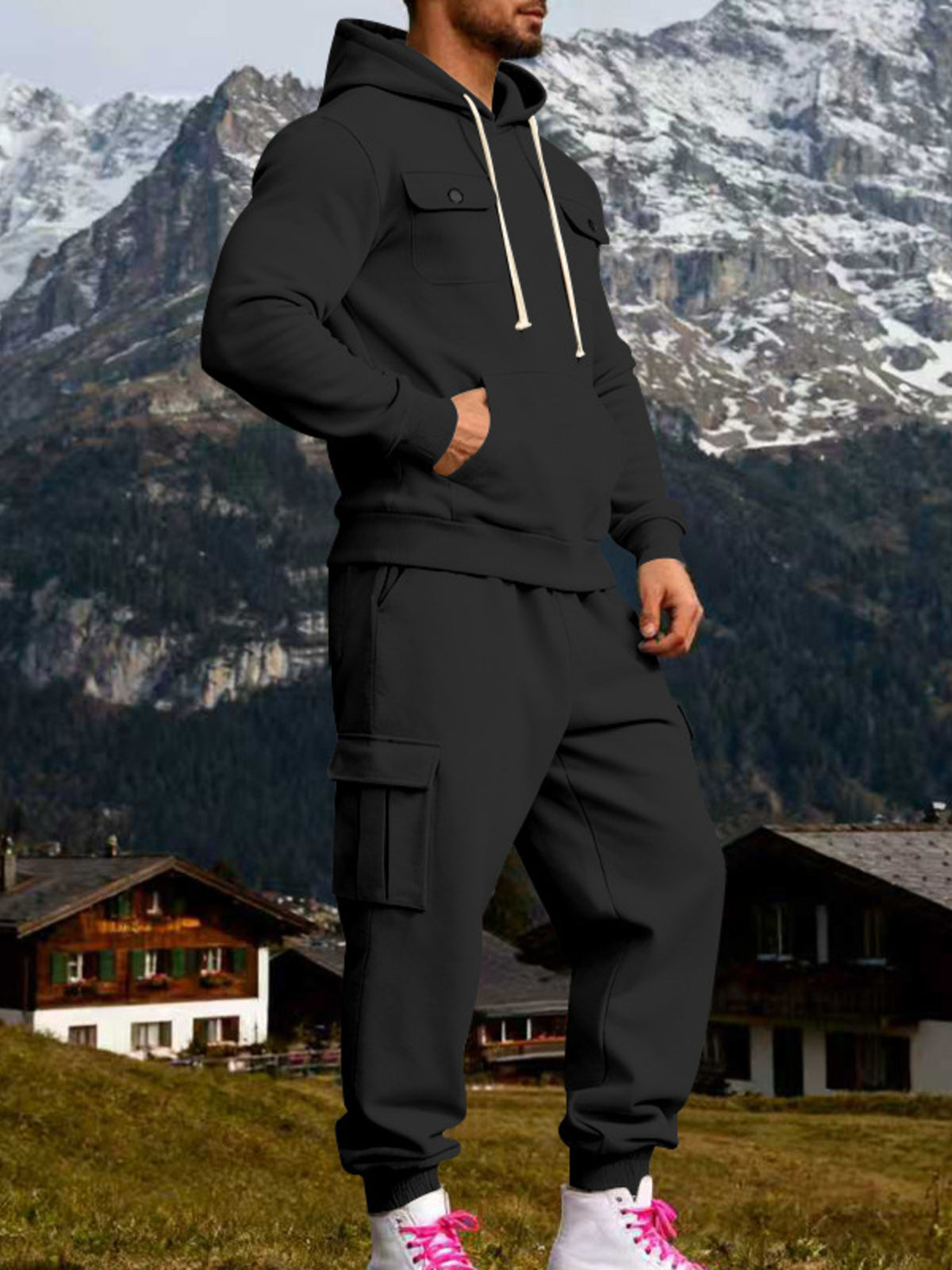 Angled view of black hoodie and cargo joggers with cream drawstrings and a kangaroo pocket