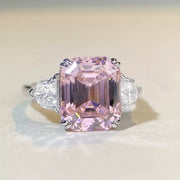 Front close-up of a blush pink rectangular zircon ring with clear triangular side stones